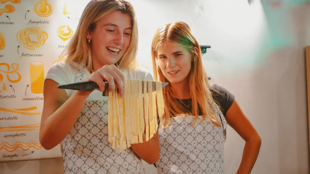 Instructor showing pasta making techniques
