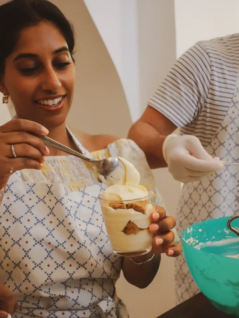 Young woman making homemade tiramisù towards the beginning of a Pasta and Tiramisu cooking class in Rome