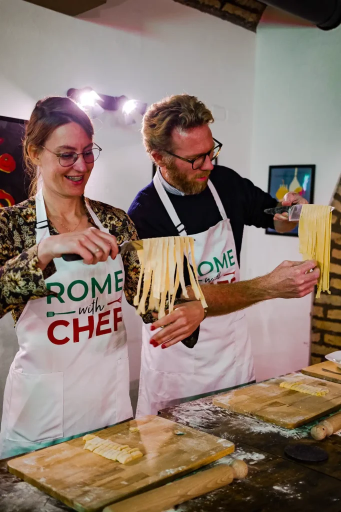 Instructor guiding students in pasta shaping