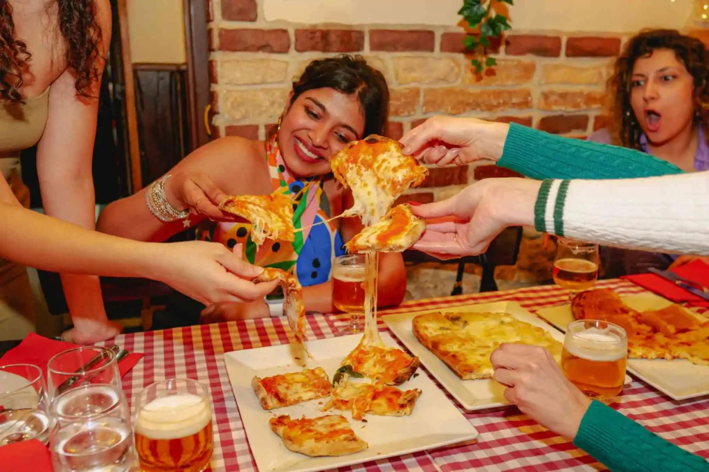 Girls enjoying pizza on our semi private Trastevere Rome food tour