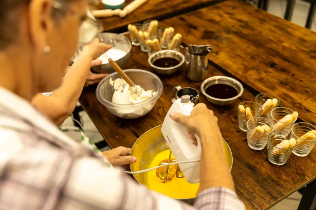 Gourmet food plating with wine glasses during fine dining Pizza & Tiramisu Class experience