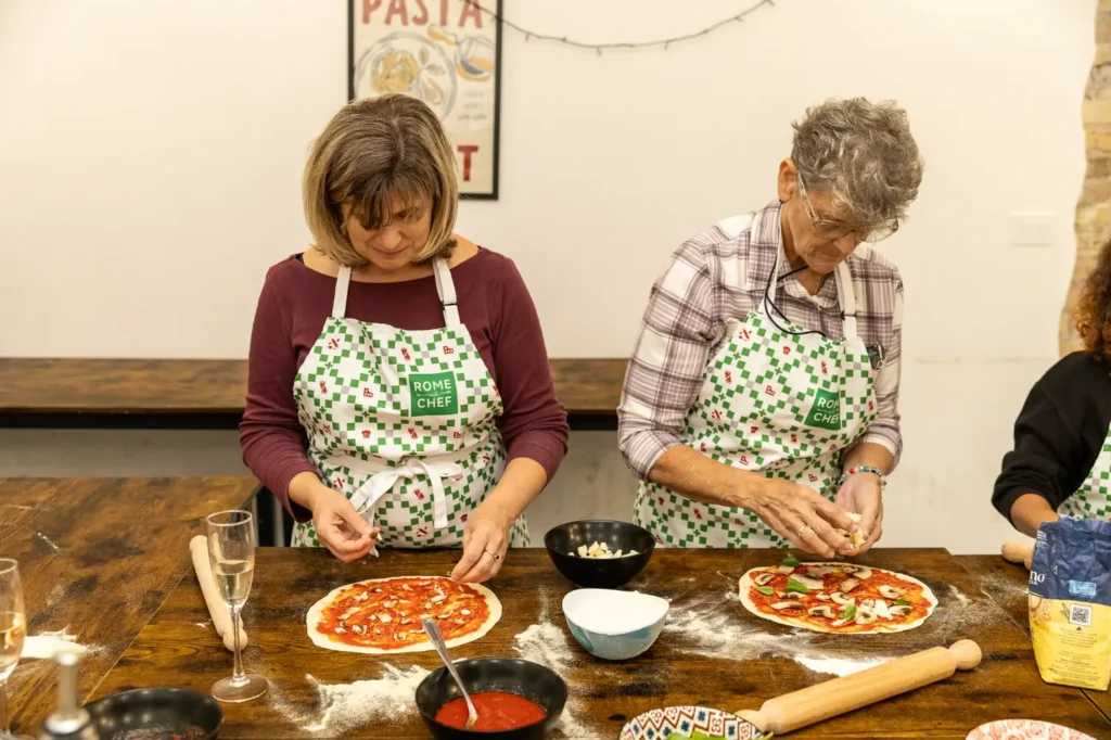 Women enjoying traditional Italian food during Pizza & Tiramisu Class experience