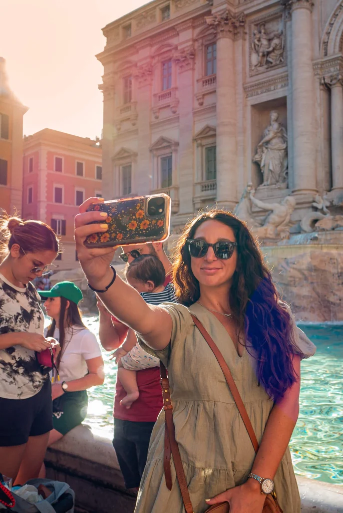 Snapping a selfie in front of the Trevi Fountain