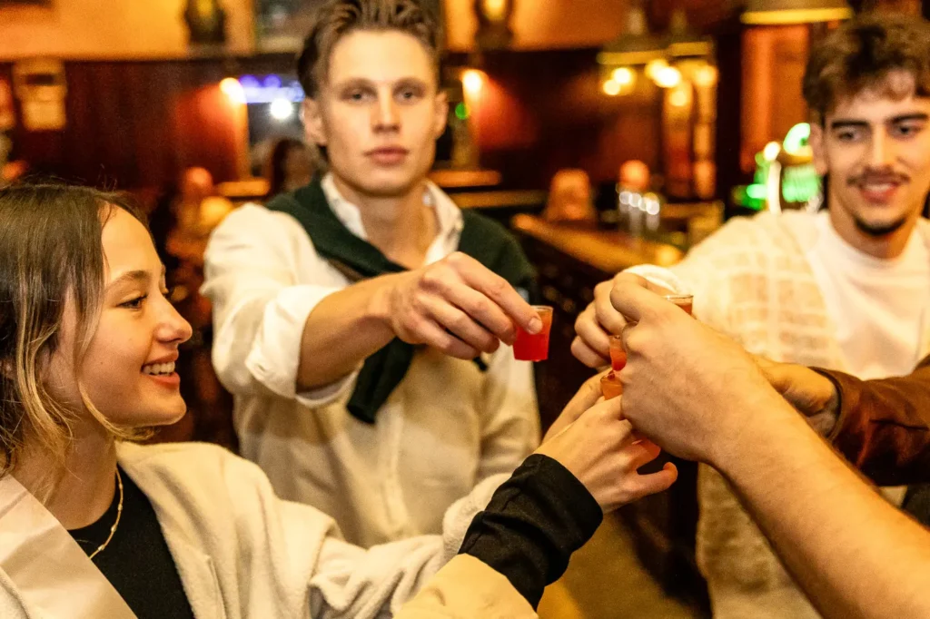 Smiling travelers sharing food and wine during Rome Tipsy Tour