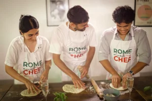 Chef making pizza with a young couple on a pizza & cocktail making class in Rome