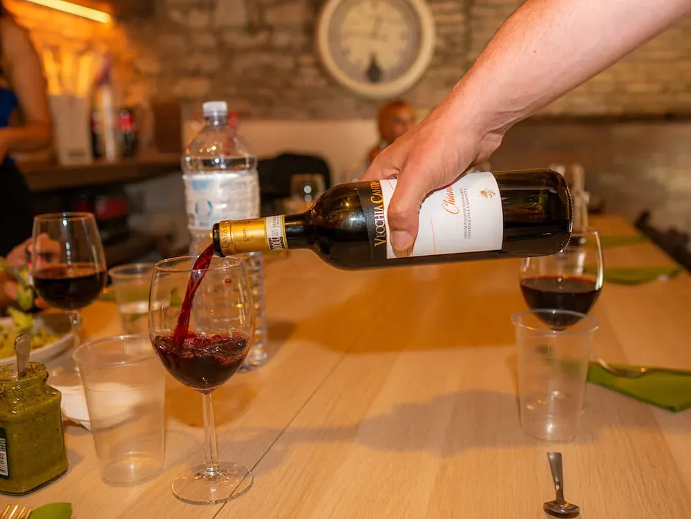 Italian red wine being poured on a Rome Food tour