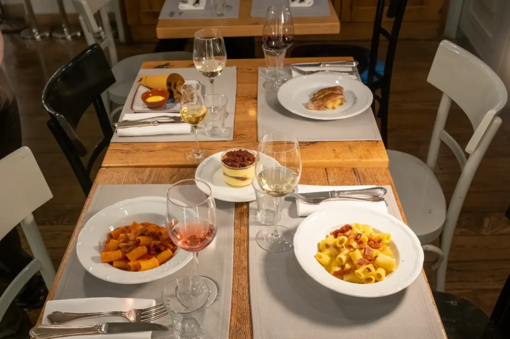 Two delicious pasta courses, including carbonara, served with wine pairings at a fine dining restaurant.